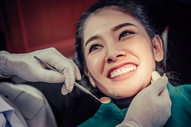 dentist treat the smiling patient