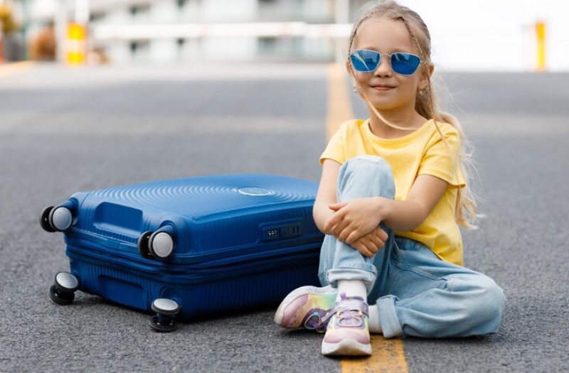 little-girl-in-yellow-shirt-with-suitcase